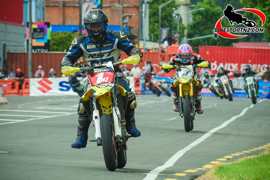 The Supermoto class was a crowd favourite on the public streets of Whanganui on Boxing Day, with UK rider Davey Todd (Suzuki RM-Z450 letter D) and local Whanganui hero Richie Dibben (Suzuki RM-Z450 No.1) close through every twist and turn. Photo by Andy McGechan, BikesportNZ.com